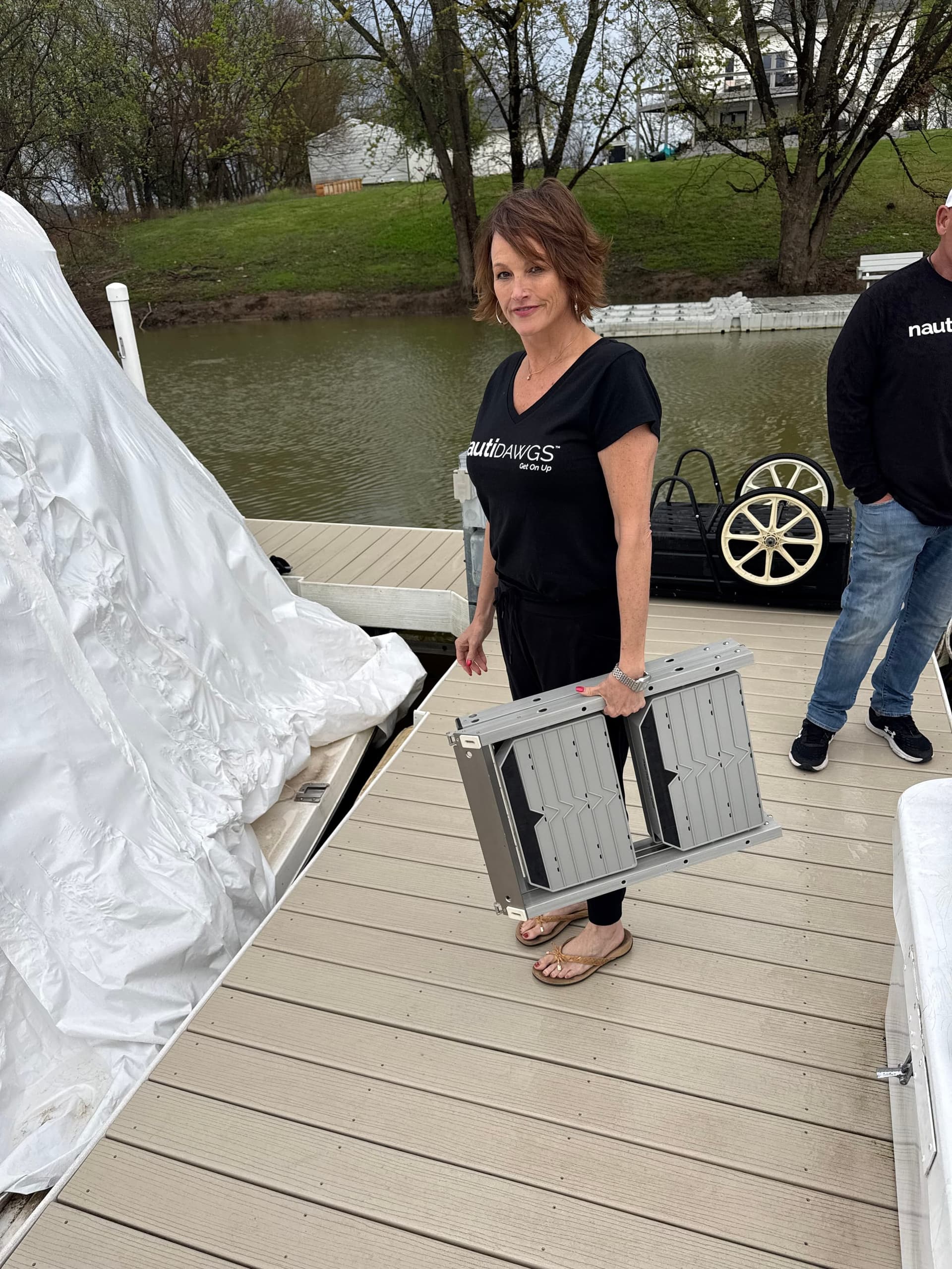 The ladder folded flat and carried in one hand down a dock